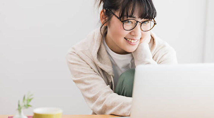 Young lady with glasses using laptop