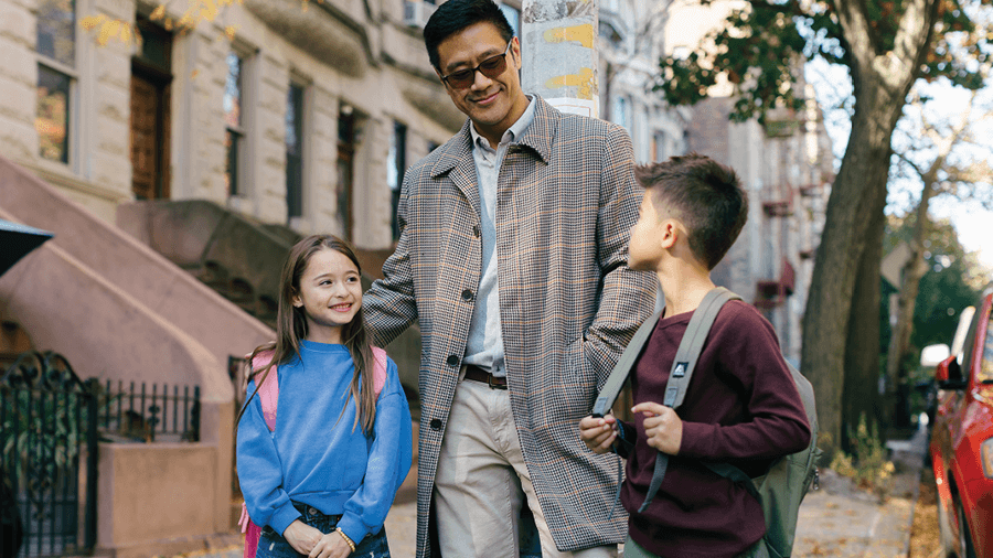 Busy parent walking children to school 