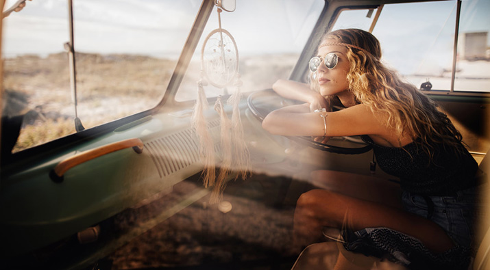 Young woman in car with sunglasses